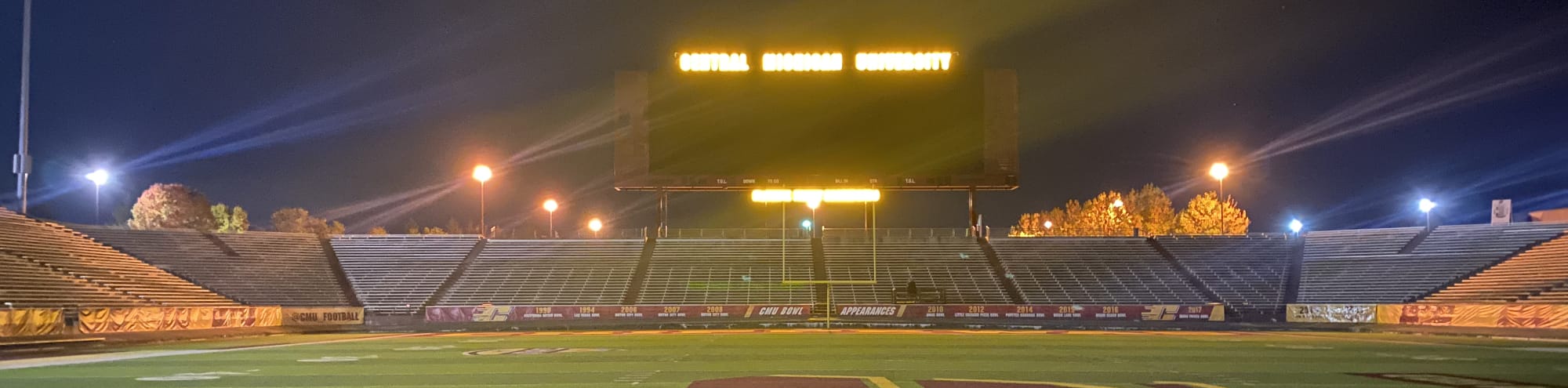empty football stadium at night under the lights Morgantown